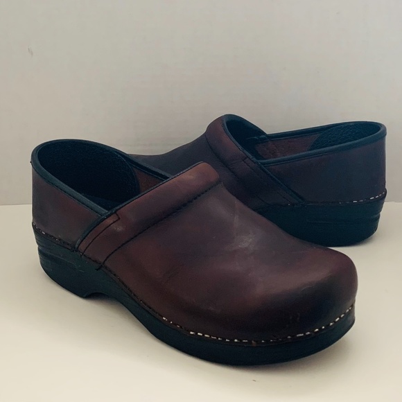 dansko distressed leather clogs